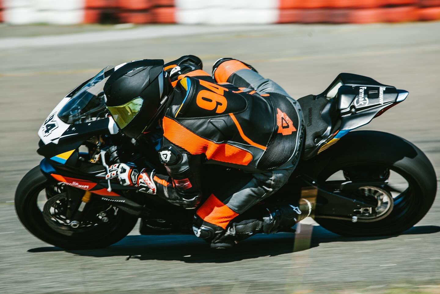 NFmoto rider on track in a custom leather race suit